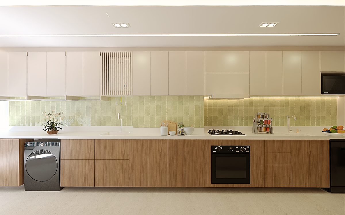 Cozinha integrada à lavanderia, com bancada contínua e revestimento verde na parede